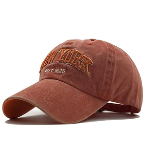 Vintage washed cotton baseball cap in rust orange with New York embroidery 45-degree view