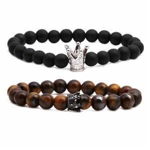 Tiger eye and matte black stone crown couples bead bracelet set on a white background