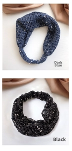 Detailed comparison of navy blue and black knit polka dot headbands with elastic bands
