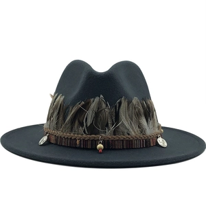Close-up of grey wool fedora featuring natural brown feathers and bohemian beaded trim