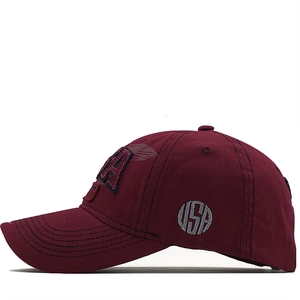 Detailed view of 3D USA embroidery and premium cotton twill on a burgundy baseball cap