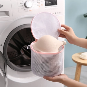 Cylindrical mesh laundry bag with pink zipper for protecting delicate underwear in washer