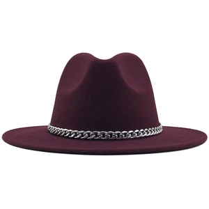 Detailed close-up of a burgundy wool fedora hat with a silver chain link band
