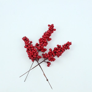 Close-up of two artificial red berry stems for Christmas and New Year DIY decoration