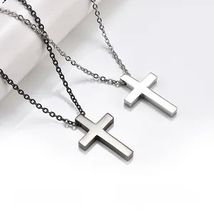 Close-up of polished black and silver stainless steel cross necklaces for men