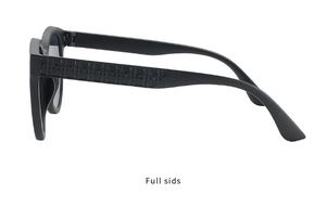 Detail view of matte black sunglasses featuring embossed geometric patterns on temples