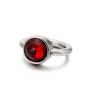 Polished silver ring with a large faceted red crystal stone in bezel setting