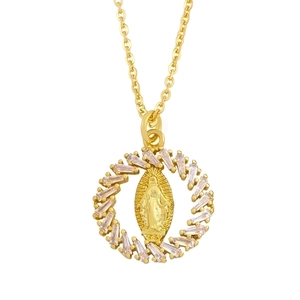 Detailed macro of a gold Virgin Mary heart pendant with baguette-cut zircon crystals
