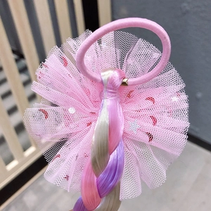 Detail of pink mesh bow with star patterns and colorful braided hair extension for girls