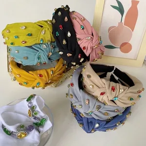 Close-up of colorful knotted headbands with baroque rhinestones in various pastel colors