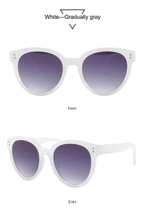 Detail of white round sunglasses with metal studs and textured temples featuring gradient lenses
