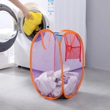 Detail view of purple mesh laundry hamper with side pocket in a laundry room