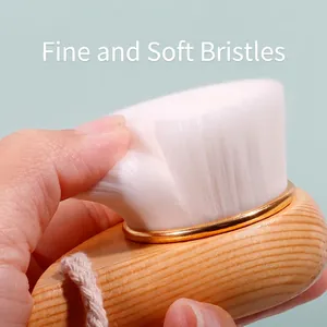 Soft facial cleansing brush with a natural beech wood handle and convenient hanging rope