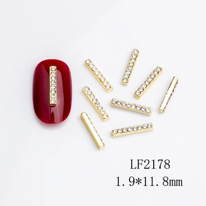 Golden nail art charms with sparkling white crystals, size 1.9x11.8mm for manicures