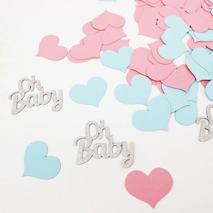 Detailed overhead view of 'Oh Baby' letter confetti with pink and blue hearts