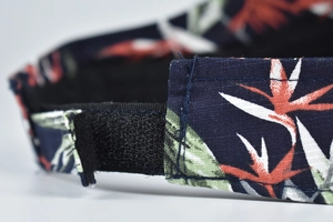 Detail of adjustable Velcro strap on floral print sun visor hat with neat stitching