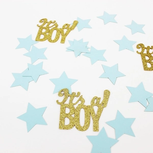 Close-up of It's a Boy gold glitter confetti and light blue star DIY party decorations