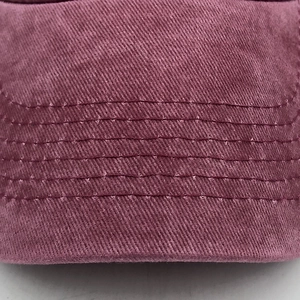 Close-up of vintage burgundy washed cotton fabric with reinforced six-row stitching details