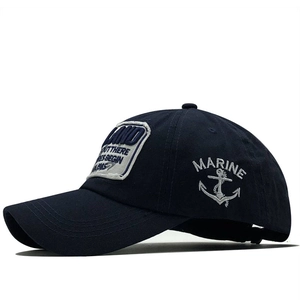 Detail of navy blue cotton baseball cap featuring nautical marine anchor embroidery