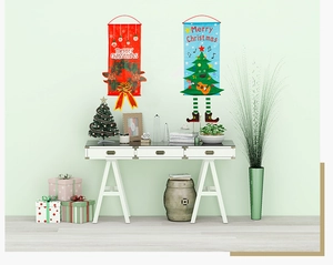 Close-up of Merry Christmas fabric banners with cartoon legs in a festive home setting