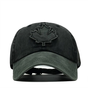 Detailed close-up of vintage washed cotton baseball cap with maple leaf embroidery
