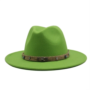 Detail of bright green wool fedora hat featuring woven band and brass scorpion plaque