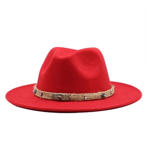 Close-up of red wide brim fedora hat with bohemian scorpion belt and turquoise bead