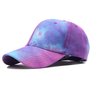 Detailed close-up of a tie-dye baseball cap featuring purple and blue cotton twill texture