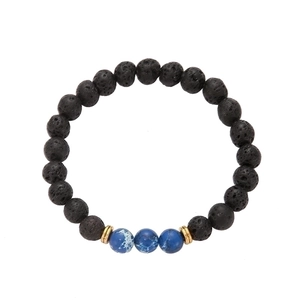 Detail of beaded bracelet featuring black volcanic stone and blue imperial beads