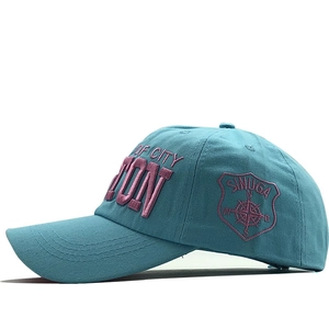 Side view detail of lake blue cotton baseball cap with 3D embroidery and curved brim