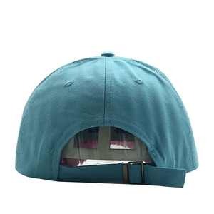 Detailed back view of blue twill cotton baseball cap featuring adjustable metal slider buckle