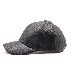 Detailed view of black baseball cap with crocodile pattern embossed PU leather texture