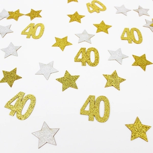 Close-up of sparkling gold and silver 40th birthday star confetti for party table decor