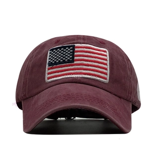 Detail of vintage burgundy cotton baseball cap with embroidered American flag patch