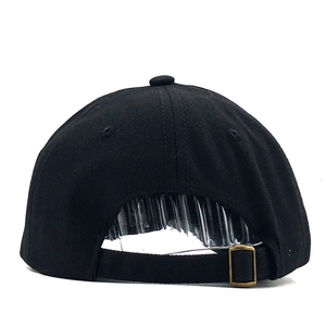 Detail of black cotton baseball cap showing adjustable back strap and bronze buckle