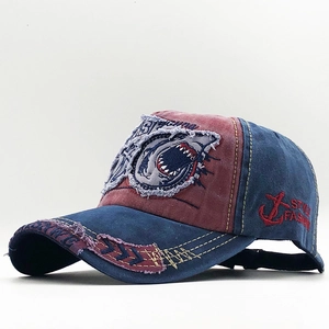 Distressed red and blue baseball cap with shark embroidery patch and retro washed finish