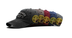 Detail view of five colors of vintage washed cotton baseball caps with Discovery embroidery
