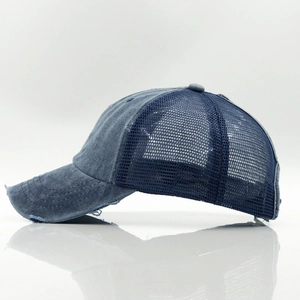 Detailed side view of washed denim trucker hat with breathable mesh and distressed edges