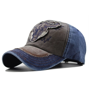 Close-up of vintage washed baseball cap featuring bull head embroidery and distressed seams