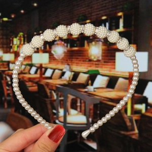 Detail of elegant pearl headband with sparkling rhinestone balls for bridal hair styling