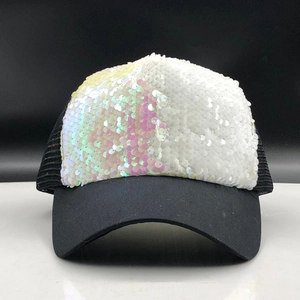 Close-up of sparkling reversible sequins and breathable mesh on a black trucker cap