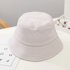 Detail view of cream cotton bucket hat featuring clean stitching and minimalist design
