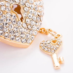 Sparkling gold heart lock and key keychain pendant with crystal rhinestones on white background