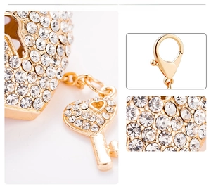 Detailed view of luxury gold heart lock and key keychain with sparkling white crystals