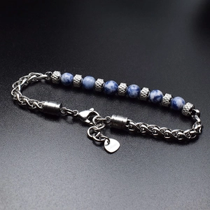 Detailed close-up of 6mm blue tiger eye stone beads on a stainless steel link bracelet