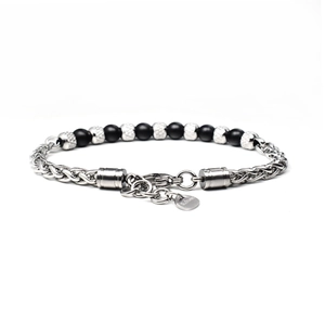 Detailed close-up of stainless steel chain bracelet with black beads and logo tag