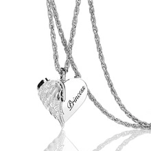 Detail of silver heart necklace with angel wing design and Princess engraving