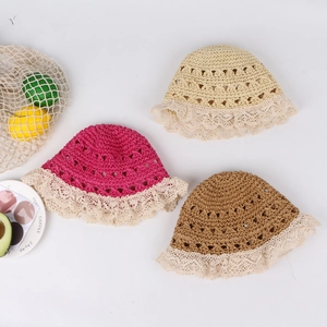 Detail of hand-woven baby sun hats with lace trim in beige, rose red and brown colors