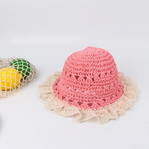 Detail of pink hand-crochet straw hat with breathable hollow patterns and white lace brim