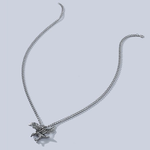 Vintage stainless steel eagle pendant necklace with classic cuban chain on grey background